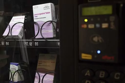 A vending machine is stocked with emergency contraceptives at Odegaard Library on the campus of the University of Washington, Friday, June 2, 2023, in Seattle. After a student-led campaign to install the emergency contraceptive vending machine on campus in November, boxes of generic Plan B have been available to students for $12.60, a fraction of the cost charged in stores. (Kevin Clark/The Seattle Times via AP)