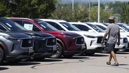 A prospective buyer surveys a row of unsold 2023 QX60 luxury sports-utility vehicles at an Infiniti dealership Sunday, Aug 27, 2023, in Highlands Ranch, Colo. (AP Photo/David Zalubowski, File)