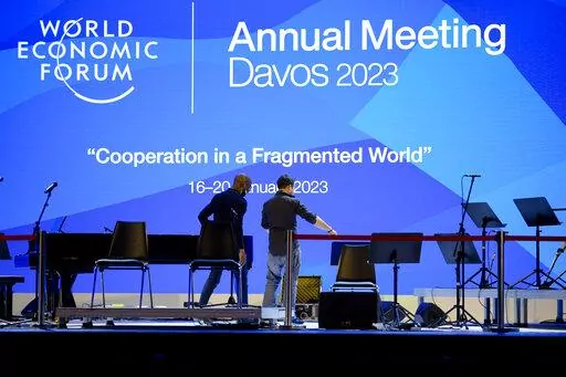 People set up the stage at the eve of the opening of the World Economic Forum in Davos, Switzerland, Sunday, Jan. 15, 2023. The annual meeting of the World Economic Forum is taking place in Davos from Jan. 16 until Jan. 20, 2023. (AP Photo/Markus Schreiber)