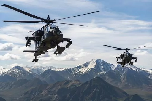 In this photo released by the U.S. Army, AH-64D Apache Longbow attack helicopters from the 1st Attack Battalion, 25th Aviation Regiment, fly over a mountain range near Fort Wainwright, Alaska, on June 3, 2019. The U.S. Army says two Army helicopters similar to the ones in this picture crashed Thursday, April 27, 2023, near Healy, Alaska, killing three soldiers and injuring a fourth. The helicopters were returning from a training flight to Fort Wainwright, based near Fairbanks. (Cameron Roxberry/