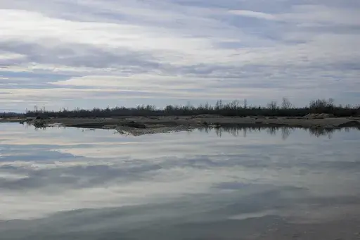 A view of the bank of the Drina River near the village of Amajlije, eastern Bosnia, Sunday, Feb. 4, 2024. In several cities along this river between Bosnia and Serbia, simple, durable gravestones now mark the final resting places of dozens of refugees and migrants who drowned in the area while trying to reach Western Europe. (AP Photo/Darko Vojinovic)