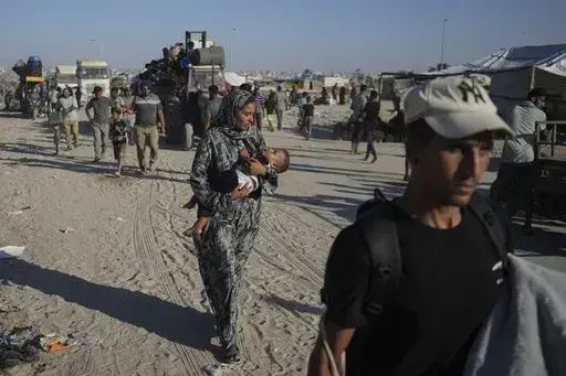 Palestinians flee the Khan Younis area of the Gaza Strip, following Israeli military evacuation orders, saying its forces will soon operate there, Thursday, Aug. 8, 2024. (AP Photo/Abdel Kareem Hana)