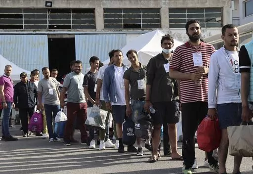Survivors of latest tragical shipwreck prepare to board a bus to transfer to Athens at the port of Kalamata, Greece, Friday, June 16, 2023. The round-the-clock effort continued off the coast of southern Greece despite little hope of finding survivors or bodies after none have been found since Wednesday, when 78 bodies were recovered and 104 people were rescued. (John Liakos/InTime News via AP)