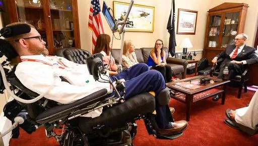 In this photo provided by The ALS Association, representatives from the group meet with former Tennessee Congressman Phil Roe, right, in his offices on Capitol Hill in Washington on March 14, 2022. The ALS Association and other patient groups have been lobbying federal officials for over a year seeking access to an experimental drug from Amylyx Pharmaceuticals. The Food and Drug Administration will soon meet to review the drug’s safety and effectiveness. (Kevin Allen/The ALS Association via AP