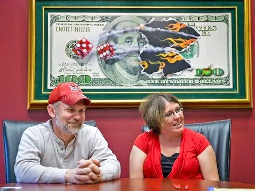 Powerball lottery winners David, left, and Erica Harrig, of Gretna, Neb., speak during an interview at the law office of their attorney Darren Carlson in Omaha, Neb., on Dec. 13, 2013. (Kent Sievers /Omaha World-Herald via AP, File)