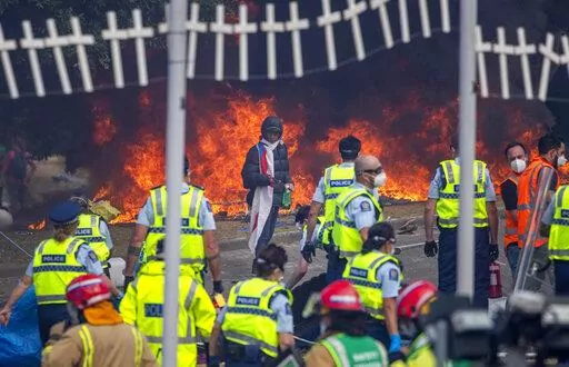 Demonstrators set fire to tents, mattresses and chairs at a protest opposing coronavirus vaccine mandates in Wellington, New Zealand, Wednesday, March 2, 2022. Since the beginning of the pandemic, New Zealand has reported fewer than 100 virus deaths among its population of 5 million, after it imposed strict border controls and lockdowns to eliminate earlier outbreaks. (Mark Mitchell/New Zealand Herald via AP)