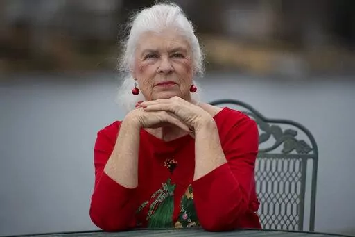 Wanda Olson poses for a photo, Friday, Dec. 17, 2021, in Villa Rica, Ga. When Olson’s son-in-law died in March after contracting COVID-19, she and her daughter had to grapple with more than just their sudden grief. They had to come up with money for a cremation. Even without a funeral, the bill came to nearly $2,000, a hefty sum that Olson initially covered. (AP Photo/Mike Stewart)