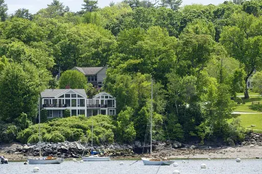 The homes of Lisa Gorman, front, and Amelia and Arthur Bond are seen, Tuesday, June 4, 2024, in Camden, Maine. The Bond's, a wealthy politically connected Missouri couple poisoned their neighbor's trees to secure a view of Camden Harbor, outraging residents in the seaside community.(AP Photo/Robert F. Bukaty)