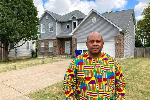 Abdul-Kaba Abdullah stands in front of his former home in St. Louis on Friday, Oct. 7, 2022. Abdullah sold the home two years ago for less than he thought it was worth after an appraisal came in lower than expected. He believes the appraisal was low because the home is in north St. Louis, a predominantly Black area of the city. St. Louis is among several U.S. cities where realtors have recently apologized for past housing discrimination and announced new efforts to protect housing rights. (AP Ph