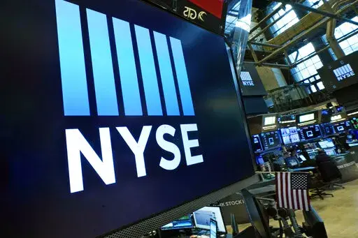 The New York Stock Exchange logo adorns a trading post on the floor of the Exchange on March 16, 2022, in New York. Stocks are rising again at the start of trading on Wall Street on Friday, Aug. 12, 2022, putting the S&P 500 on track for its first four-week winning streak since November. (AP Photo/Richard Drew, File)
