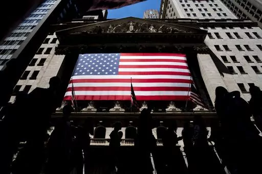 People walk past the New York Stock Exchange on Wednesday, June 29, 2022 in New York. Wall Street’s best week of the year is getting even better Friday, Nov. 3, 2023, following a cooler-than-expected report on the job market. (AP Photo/Julia Nikhinson)