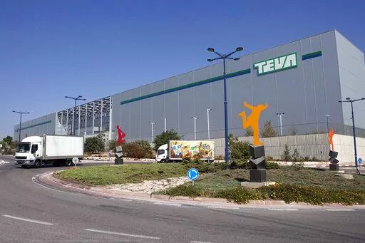 FILE - Trucks drive in front of Teva Pharmaceutical Logistic Center in the town of Shoam, Israel, Oct. 16, 2013. A jury held Teva Pharmaceuticals responsible, Thursday, Dec. 30, 2021, for contributing to the opioid crisis, delivering a verdict in a sweeping lawsuit filed by New York state, the state attorney general said. (AP Photo/Dan Balilty, File)