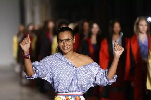 Designer Stella Jean accepts applause at the end of her womens Spring/Summer 2018/19 fashion collection, presented in Milan, Italy, on Sept. 24, 2017. Stella Jean, the only Black designer belonging to Italy’s fashion council is withdrawing from this month’s Milan Fashion Week citing a lack of commitment to diversity and inclusion, and on Wednesday Feb. 8, 2023 announced a hunger strike out of concern that other minority designers associated with her will suffer a backlash. (AP Photo/Luca Bru