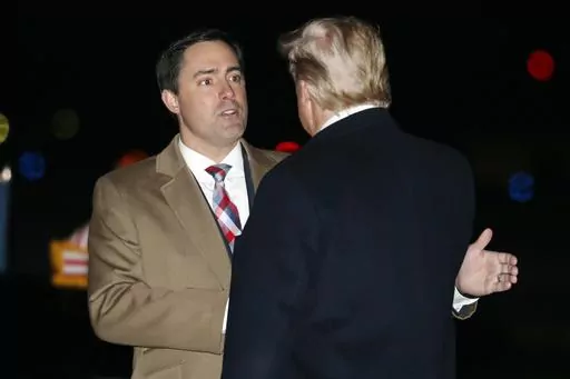 President Donald Trump greets Ohio Secretary of State Frank LaRose, Jan. 9, 2020, as he arrives at Toledo Express Airport, in Swanton, Ohio. The Republican secretaries of state in Ohio, West Virginia and Missouri all have promoted their states’ elections as fair and secure. Yet each also is navigating a fine line on how to address election fraud conspiracies, as they eye campaigns for U.S. Senate or governor in 2024. (AP Photo/ Jacquelyn Martin, File)