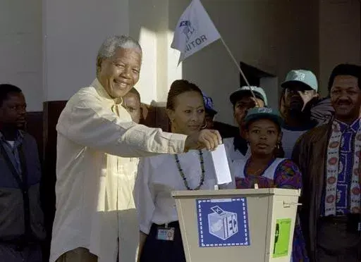 Then African National Congress leader, Nelson Mandela casts his vote April 27, 1994 near Durban, South Africa, in the country's first all-race elections. South Africans celebrate "Freedom Day" every April 27, when they remember their country's pivotal first democratic elections in 1994 that announced the official end of the racial segregation and oppression of apartheid. (AP Photo/John Parkin. File)