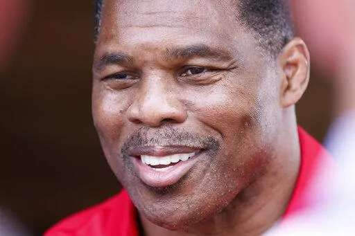 Herschel Walker, the Republican nominee for the state's U.S. Senate seat, takes questions from the media after a campaign event July 20, 2022, in Athens, Ga. A new report says Georgia Republican Senate nominee Herschel Walker paid for an abortion for his girlfriend in 2009. Walker has vehemently opposed abortion rights and calls the accusation in The Daily Beast a “flat-out lie." The Daily Beast spoke to a woman who said Walker paid for her abortion when they were dating. (Miguel Martinez/Atla