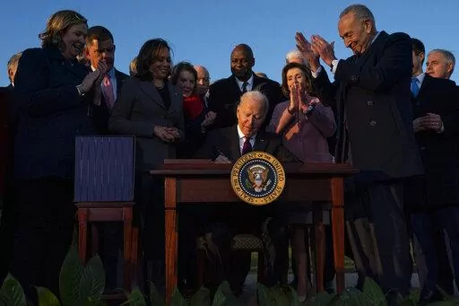 President Joe Biden signs the "Infrastructure Investment and Jobs Act" during an event on the South Lawn of the White House, Nov. 15, 2021, in Washington. Biden will deliver his State of the Union address to a joint session of Congress on Tuesday, March 1, 2022. (AP Photo/Evan Vucci, File)