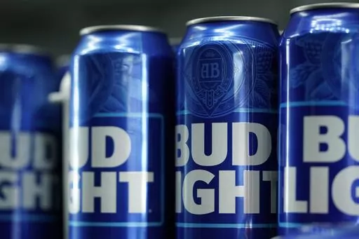 Cans of Bud Light beer are seen before a baseball game between the Philadelphia Phillies and the Seattle Mariners on April 25, 2023, in Philadelphia. The country's largest advocacy group for LGBTQ+ rights has suspended its benchmark equality and inclusion rating for Anheuser-Busch, citing the beer company's handling of hate-filled and transphobic backlash received after its partnership with transgender influencer Dylan Mulvaney in April. (AP Photo/Matt Slocum, File)