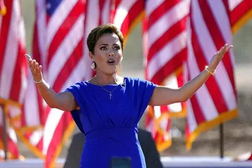 Arizona Republican gubernatorial candidate Kari Lake arrives to a rally with former President Donald Trump on Oct. 9, 2022, in Mesa, Ariz. The Republicans running for Arizona's three top statewide offices have said they would not have signed off on the presidential results if they had held office in 2020 and have signaled that they want to overhaul the battleground state's elections.(AP Photo/Matt York, File)