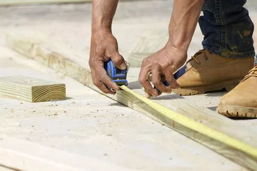 A beam is measured and marked at a housing site in Madison County, Miss., Tuesday, March 16, 2021. Homeowners have been spending more for renovations in recent years, as high interest rates and inflation drove up costs for everything from flooring to refrigerators. (AP Photo/Rogelio V. Solis, File)