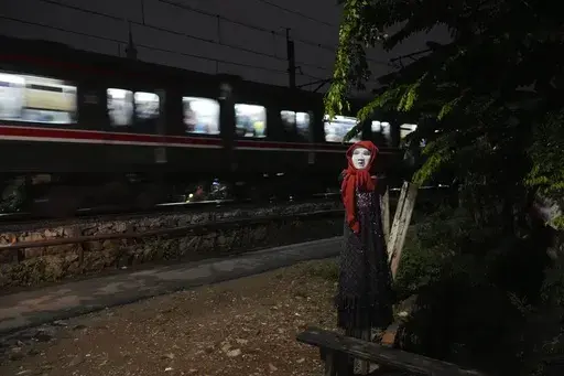 An effigy is seen near a railway track where two commuter trains collided in 1987, killing 139 people, in Bintaro, Indonesia, Friday, Oct. 25, 2024. (AP Photo/Tatan Syuflana)