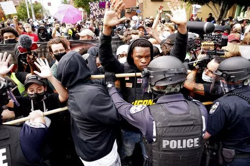 Police and protesters converge during a demonstration, Wednesday, Sept. 23, 2020, in Louisville, Ky.  Recent revelations about the search warrant that led to Breonna Taylor’s death have reopened old wounds in Louisville’s Black community and disrupted the city’s efforts to restore trust in the police department. (AP Photo/John Minchillo, File)
