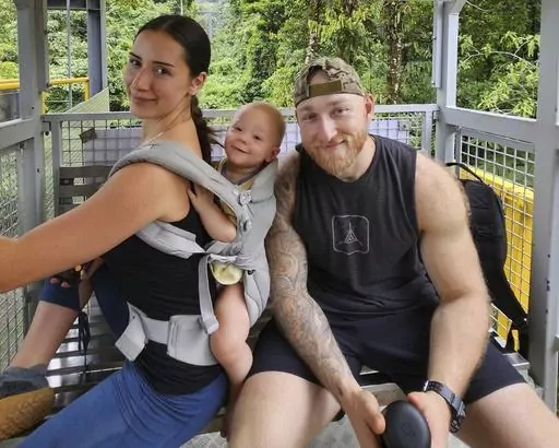 This undated photo provided by John Flickinger, Friday, April 5, 2024, shows Sandy Leclerc, left, and Jacob Flickinger with their son Jasper. Flickinger was one of seven World Central Kitchen aid workers unloading food from their vehicles when they were killed by Israeli airstrikes Monday, April 1, in Gaza. (John Flickinger via AP)