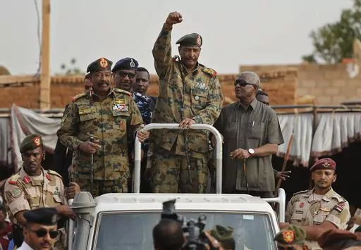 Sudanese Gen. Abdel-Fattah Burhan, head of the military council, waves to his supporters upon his arrival to attend a military-backed rally, in Omdurman district, west of Khartoum, Sudan, Saturday, June 29, 2019.(AP Photo/Hussein Malla, File)