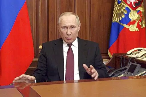 In this image made from video released by the Russian Presidential Press Service, Russian President Vladimir Putin addressees the nation in Moscow, Russia, Thursday, Feb. 24, 2022. Russian troops launched their anticipated attack on Ukraine on Thursday, as Putin cast aside international condemnation and sanctions and warned other countries that any attempt to interfere would lead to "consequences you have never seen."  (Russian Presidential Press Service via AP)