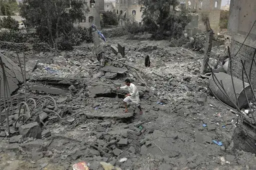 A Yemeni walks over the debris of a destroyed building following U.S. airstrikes in Sanaa, Yemen, Monday, March 24, 2025. (AP Photo)