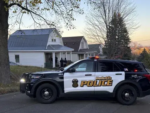 Police investigate the scene where five people were found shot to death inside two homes in Duluth, Minn., on Thursday, Nov. 7, 2024. (Christa Lawler/Star Tribune via AP)