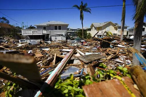 A road is completely filled with a tall pile of debris from destroyed beachfront homes and businesses, two days after the passage of Hurricane Ian, in Fort Myers Beach, Fla., Sept. 30, 2022. Florida's home insurance market was already on shaky ground. It now faces an even mightier struggle after the damage caused by the hurricane. (AP Photo/Rebecca Blackwell, File)