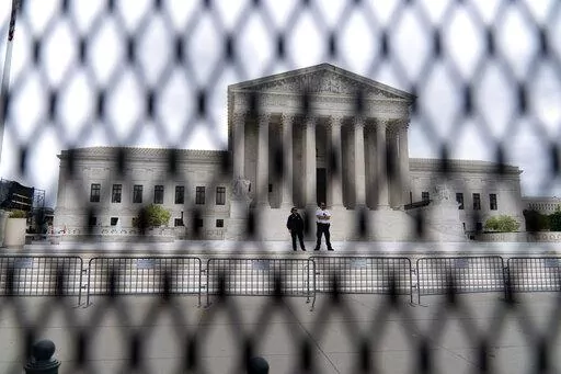 The U.S. Supreme Court is seen behind a fence who stands around the building on Thursday, May 5, 2022 in Washington. One proposal pending in Congress would provide additional security measures for the justices and another would offer more privacy and protection for all federal judges. (AP Photo/Jose Luis Magana, File)