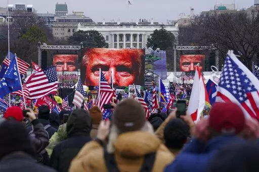 In this Jan. 6, 2021 file photo, Trump supporters participate in a rally in Washington. On Friday, Oct. 21, 2022, The Associated Press reported on stories circulating online incorrectly claiming that former President Donald Trump signed an order to deploy 20,000 National Guard troops before his supporters stormed the U.S. Capitol on Jan. 6, 2021, but was stopped by the House sergeant at arms, at the behest of Speaker Nancy Pelosi.  (AP Photo/John Minchillo, FIle)