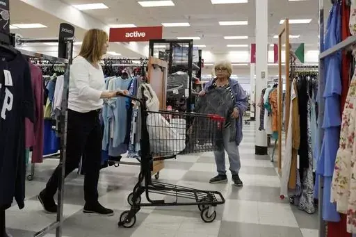 Customers shop at a retail store in Vernon Hills, Ill., Monday, June 12, 2023. The most-anticipated recession probably in modern U.S. history still hasn't arrived. Despite higher borrowing costs, thanks to the Federal Reserve's aggressive streak of interest rate hikes, consumers keep spending, and employers keep hiring. (AP Photo/Nam Y. Huh)