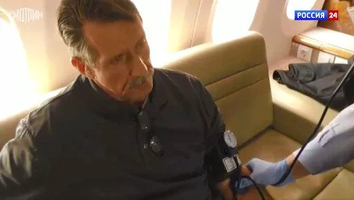 In this image taken from video provided by RU-24 Russian Television on Friday, Dec. 9, 2022, Russian citizen Viktor Bout who was exchanged for U.S. basketball player Brittney Griner, sits in a Russian plane after a swap, in the airport of Abu Dhabi, United Arab Emirates. Russian arms dealer Bout, who was released from U.S. prison in exchange for WNBA star Griner, is widely labeled abroad as the "Merchant of Death" who fueled some of the world's worst conflicts but seen at home as a swashbuckling