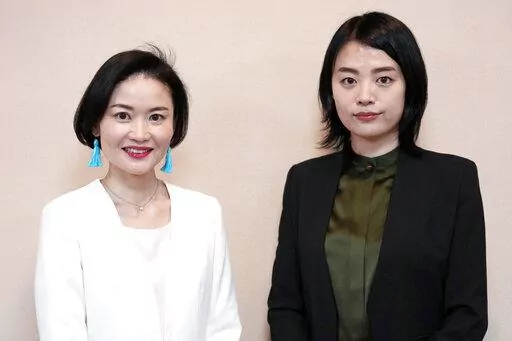 Prosecutors Tomoko Suzuki, left, and Rina Ito pose for a photographer during an interview at Tokyo District Public Prosecutors Office Monday, Feb. 27, 2023, in Tokyo. Twenty years ago, only about 8% of Japanese prosecutors were women. By 2018, that number rose to nearly a third of newly hired prosecutors. This year, the male-female ratio reached 50-50, according to the Tokyo District Prosecutors Office. (AP Photo/Eugene Hoshiko)