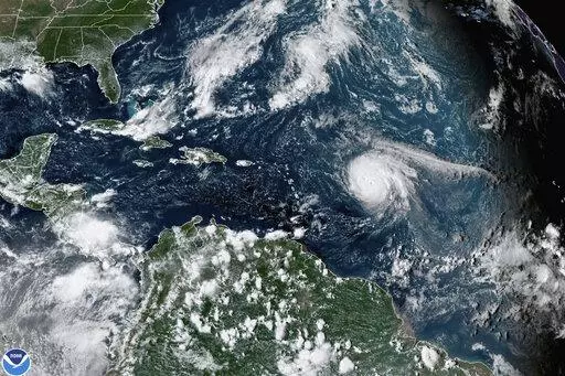 This satellite image provided by the National Oceanic and Atmospheric Administration shows Hurricane Sam, center right, in the Atlantic Ocean, Monday, Sept. 27, 2021, at 3:20 p.m. ET. On Tuesday, May 24, 2022, federal meteorologists say the Atlantic should expect another extra busy hurricane season in 2022. Tuesday's National Oceanic and Atmospheric Administration's Atlantic hurricane season forecast calls for 14 to 21 named storms, with six to 10 becoming hurricanes. (NOAA via AP, File)