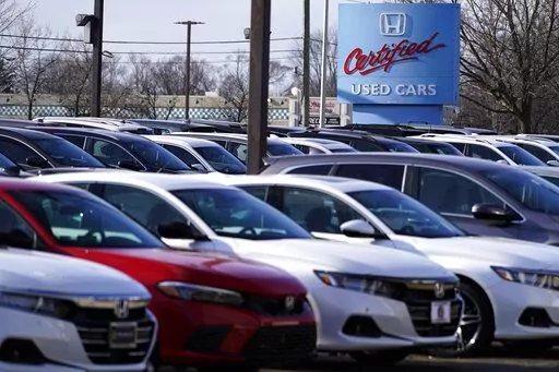 A dealership sign is seen outside of Honda certified used car dealership in Schaumburg, Ill., Thursday, Dec. 16, 2021.  Prices for used cars have soared so high, so fast, that buyers are being increasingly priced out of the market. (AP Photo/Nam Y. Huh)
