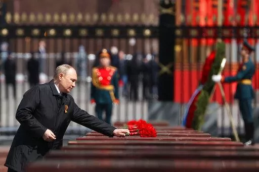 Russian President Vladimir Putin attends a wreath-laying ceremony at the Tomb of the Unknown Soldier after the military parade marking the 77th anniversary of the end of World War II in Moscow, Russia, Monday, May 9, 2022. (Anton Novoderezhkin, Sputnik, Kremlin Pool Photo via AP)