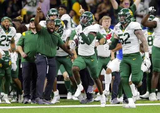 Baylor cornerback Al Walcott (13) runs 96 yards for a touchdown after intercepting a pass during the Sugar Bowl NCAA college football game against Mississippi Saturday, Jan. 1, 2022 in New Orleans. (David Grunfeld/The Times-Picayune/The New Orleans Advocate via AP)