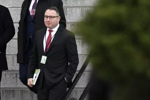 In this Jan. 27, 2020, file photo Army Lt. Col. Alexander Vindman, a military officer at the National Security Council who testified during the impeachment hearings on Capitol Hill, walks down the steps of the Eisenhower Executive Office Building on the White House complex in Washington. Vindman who was a pivotal witness in the first impeachment case against Donald Trump has sued the oldest son of the former president and other Trump allies, accusing them of participating in an “intentional, c
