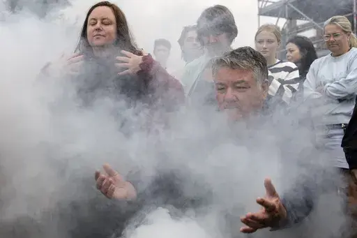 People gather for a traditional Aboriginal smoking ceremony during the We-Akon Dilinja Mourning Reflection Ceremony on Australia Day in Melbourne, Sunday, Jan. 26, 2025. (Diego Fedele/AAP Image via AP)