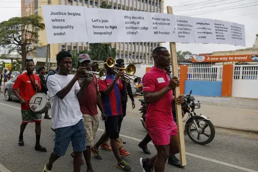 Texas Kadri Moro, the Executive Director of Arise for Justice International, protests with placards nailed on a cross on the street of Accra, Ghana, Thursday Sept 12, 2024. Texas Kadiri Moro is an unusual figure amid the LGBTQ+ rights activists in the coastal West African nation of Ghana. He is heterosexual, married to a woman and a father of six. He is a teacher. And he is a practising Muslim. (AP Photo/ Misper Apawu)