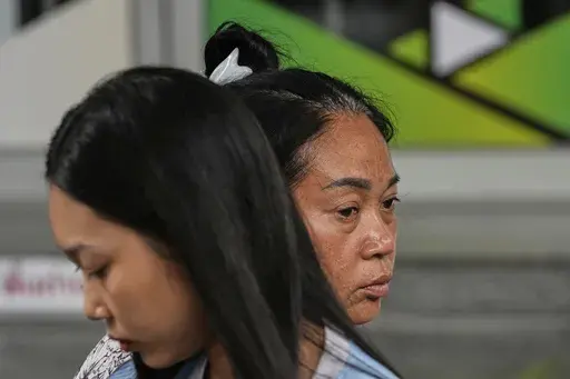 Naruemol Thonglek, right, with her daughter, waits for news of her partner, who is missing after the collapse of an under-construction high-rise building after an earthquake in Bangkok, Thailand, Monday, March, 31, 2025. (AP Photo/Manish Swarup)