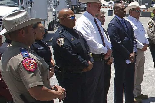 Uvalde School Police Chief Pete Arredondo, third from left, stands during a news conference outside of the Robb Elementary school in Uvalde, Texas Thursday, May 26, 2022. (AP Photo/Dario Lopez-Mills)
