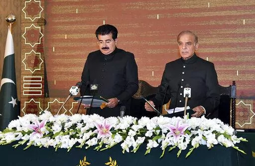 In this photo released by Press Information Department, acting President of Pakistan Sadiq Sanjrani, left, administers the oath of office to newly elected Pakistani Prime Minister Shahbaz Sharif during a ceremony at Presidential Palace, in Islamabad, Pakistan, Monday, April 11, 2022. Pakistan's parliament elected opposition lawmaker Sharif as the new prime minister Monday, following a week of political turmoil that led to the weekend ouster of Premier Imran Khan. (Press Information Department vi