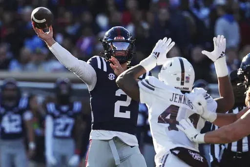 Mississippi quarterback Jaxson Dart (2) passes while being pressured by Mississippi State linebacker Branden Jennings (44) during the first half of an NCAA college football game, Friday, Nov. 29, 2024, in Oxford, Miss. (AP Photo/Rogelio V. Solis)