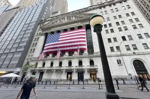 People pass the New York Stock Exchange on May 28, 2024, in New York. Global shares have advanced on Friday, June 28, 2024, as traders look ahead to a key report on inflation that could influence the Federal Reserve's next move on interest rates. (AP Photo/Peter Morgan, File)