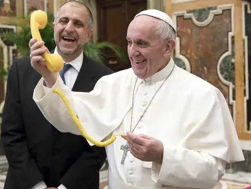 Pope Francis shares a light moment with "Telefono Amico" support hotline president Dario Briccola during an audience at the Vatican Saturday, March 11, 2017. (L'Osservatore Romano/Pool Photo via AP, File)